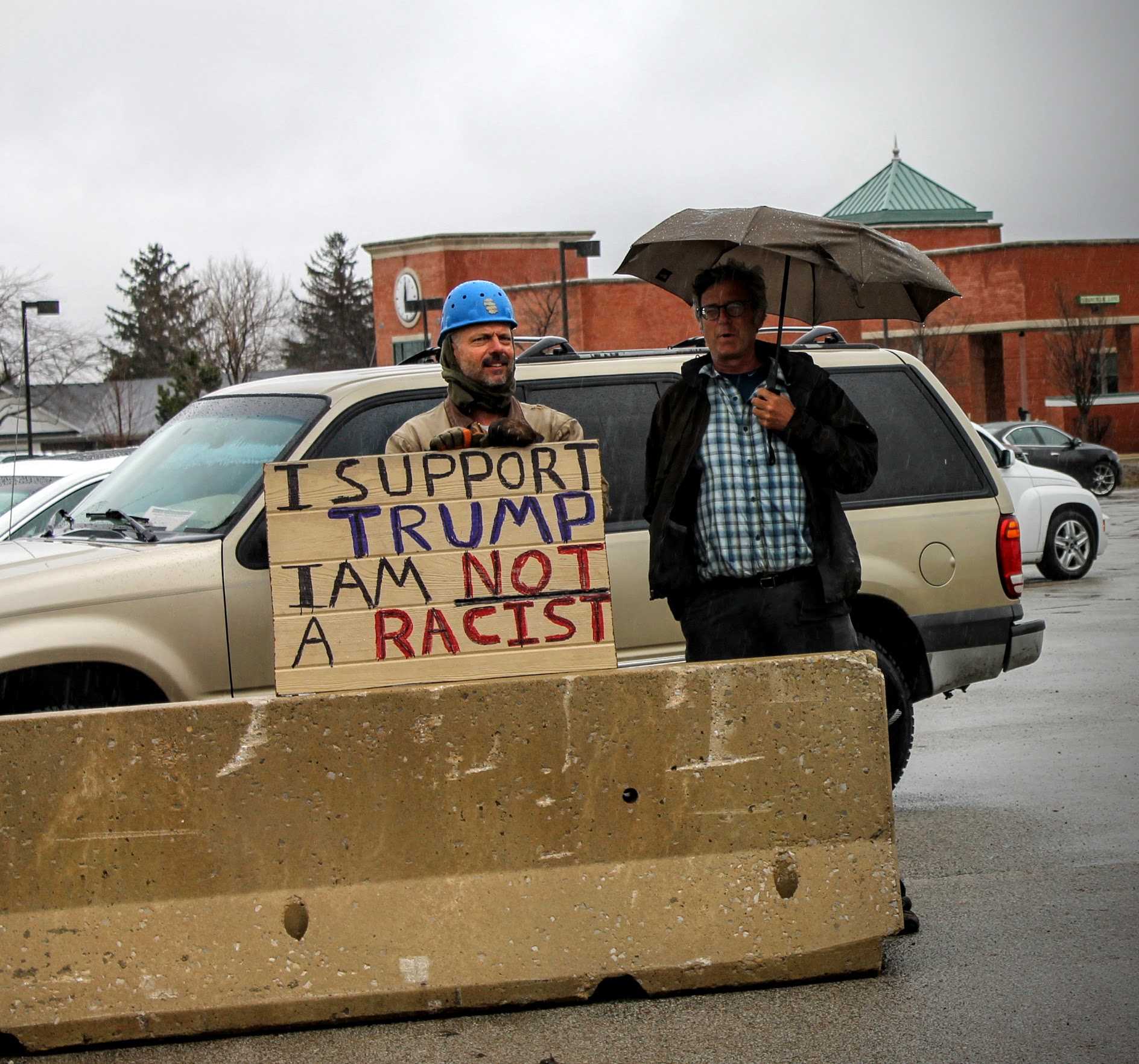 Trump supporters clarify that they aren't racist outside of the Synergy Center at the Central Illinois Regional Airport.
