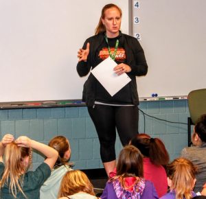 Maggie Nelson gives the girls of Heart and Sole a pep talk prior to running on the trail.