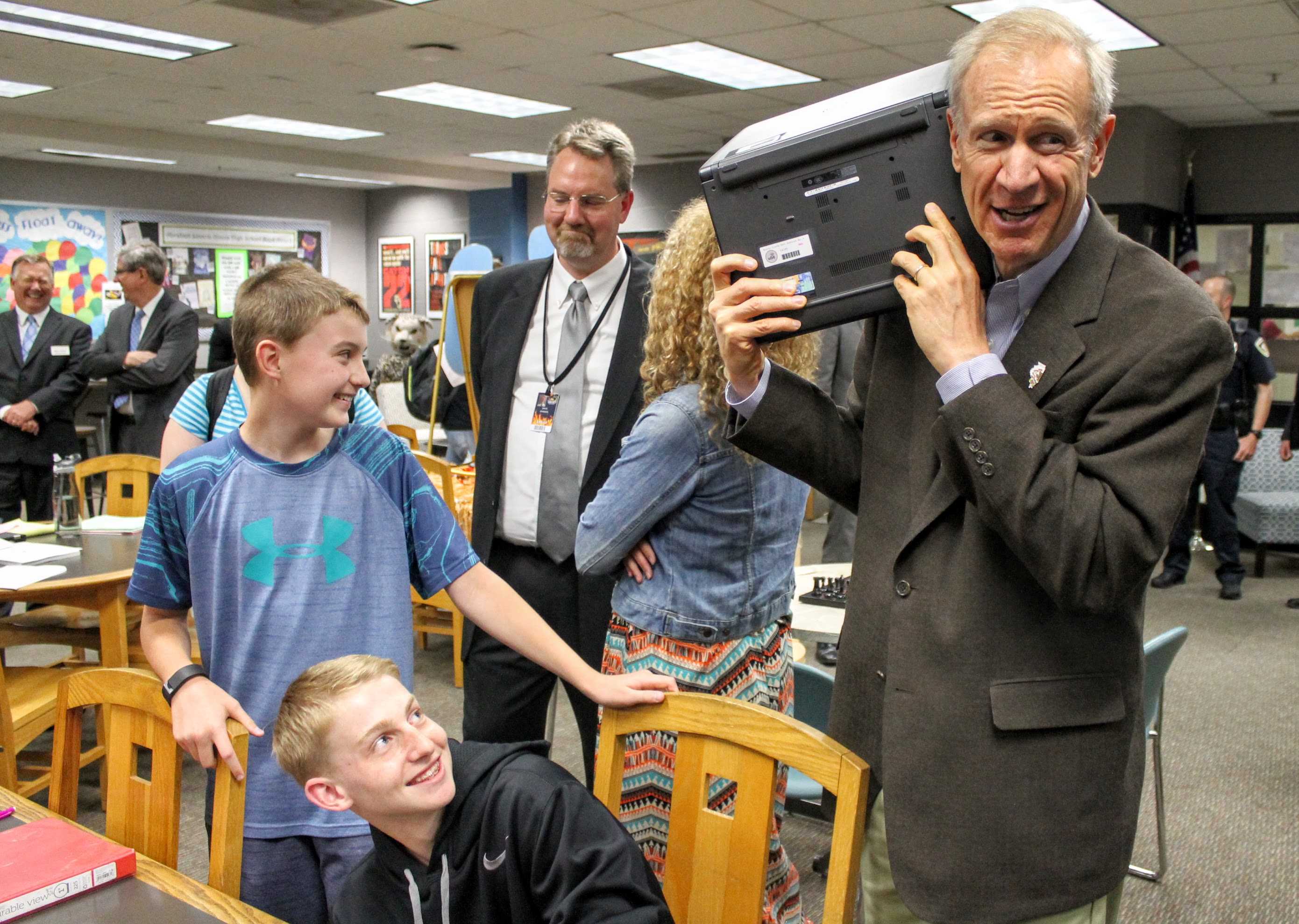 Governor Rauner inspects district technology during touring the Normal West library.
