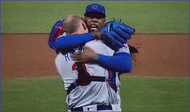 Catcher+David+Ross+and+closer+Aroldis+Chapman+hug+in+relief+after+the+Cubs+win+the+NLCS
