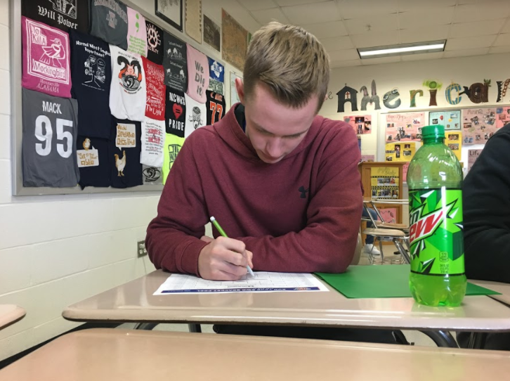 Keegan+McClure%2811%29+filling+out+his+%22winning%22+bracket+during+his+homeroom+period.+